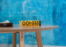Load image into Gallery viewer, Modern round dining table. Handmade in the us. With a tapered pedestal legs with blackened steel supports.