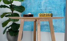 Load image into Gallery viewer, Modern round dining table. Handmade in the us. With a tapered pedestal legs with blackened steel supports.
