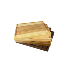 Load image into Gallery viewer, Set of stacked, handmade cutting boards on display, varying in wood species.
